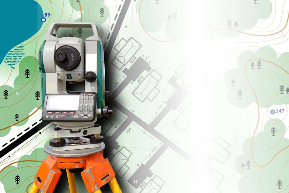 A theodolite on an orange tripod sits on a topographic map, perfectly poised for Land Surveyors in Indian River County. The map, featuring contour lines, roads, trees, and bodies of water, is partially visible in the background. The theodolite is positioned to the left.